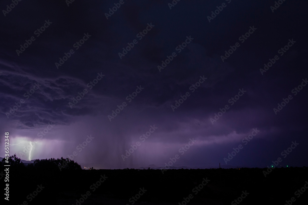 A powerful monsoon thunderstorm at night with lightning