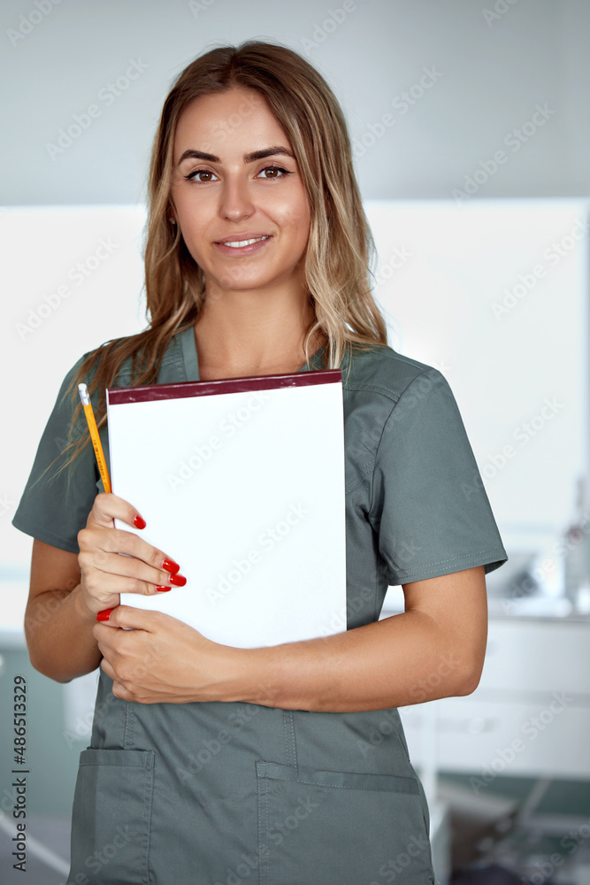 Smiling female doctor in hospital corridor. Patients consultation. Smiling female doctor in hospital corridor. Patients consultation.