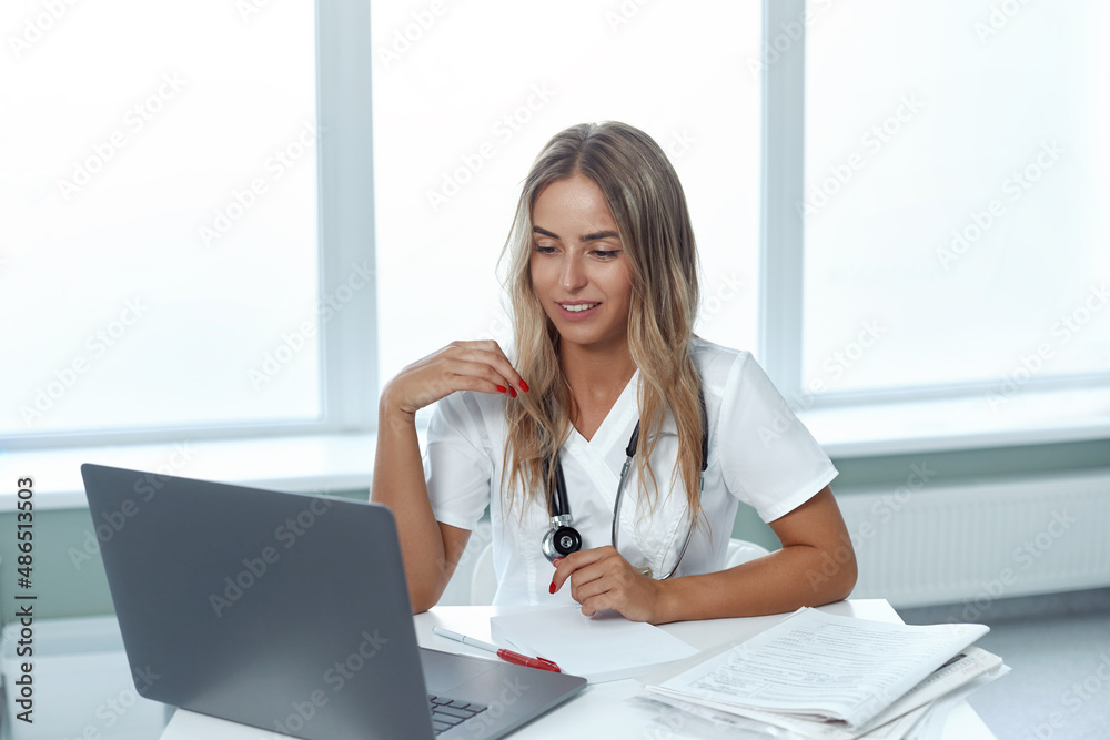 Portrait of a smiling woman doctor, consult patient client online, medicine and technology concept Portrait of a smiling woman doctor, consult patient client online, medicine and technology concept