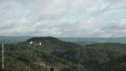 Wallpaper Mural Timelapse of thick clouds moving over green tree covered hills with few houses Torontodigital.ca