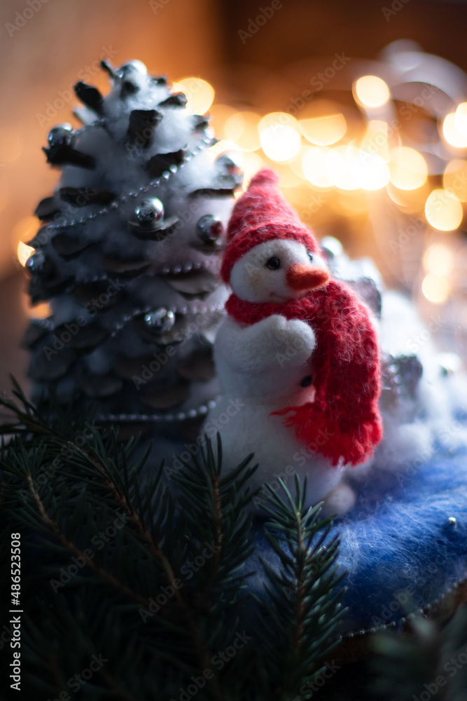 New Year's composition with hand-made Snowman with a red knitted scarf and hat.