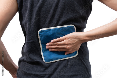 woman putting an ice pack on her back pain on white background, healthy concept photo