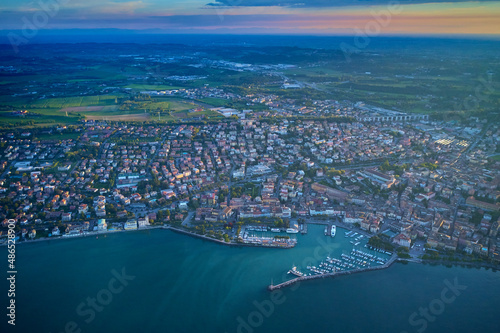 Aerial panorama of the town of Desenzano del Garda on Lake Garda in Italy. Top view of the boat parking on the lake. Italian resorts on Lake Garda. Aerial view of Desenzano del Garda. © Berg