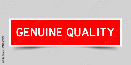 Sticker label with word genuine quality in red color on gray background