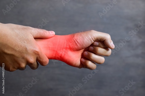 Inflammation of Asian man wrist joint and hand. Concept of joint pain and hand problems.