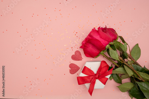 Kraft Gift box with beautiful red ribbon and rose, concept of Valentine's, anniversary, mother's day and birthday greeting, copyspace, topview.