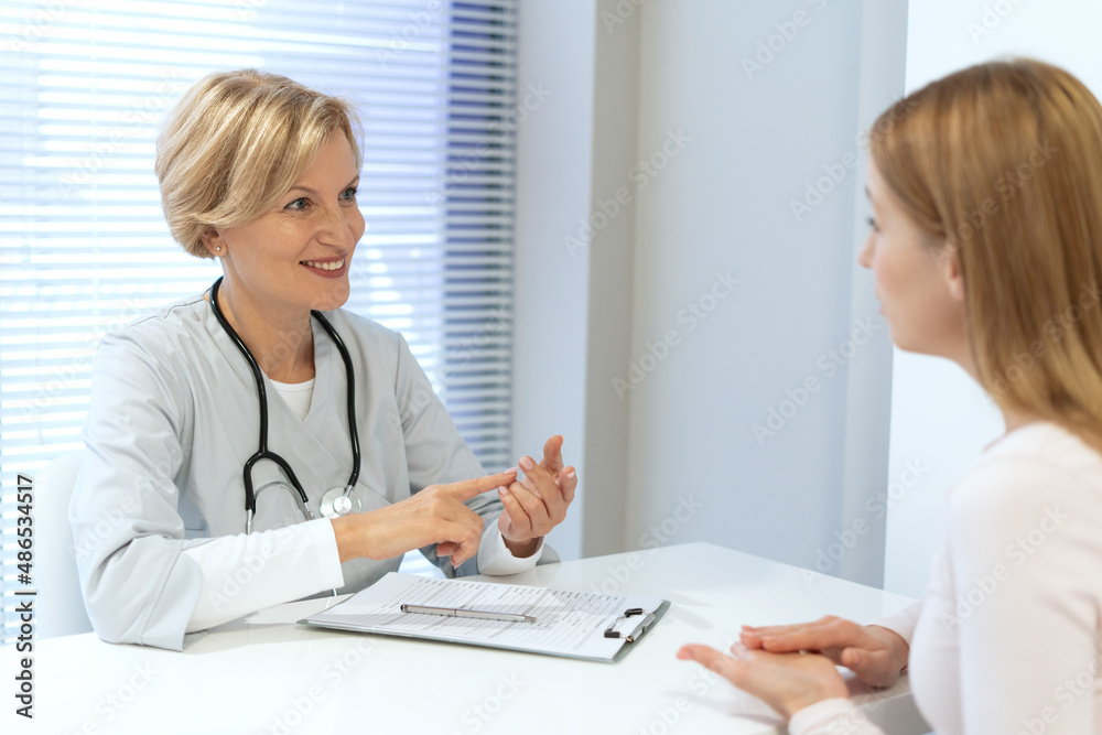 General practitioner consulting female patient in clinic General practitioner consulting female patient in clinic