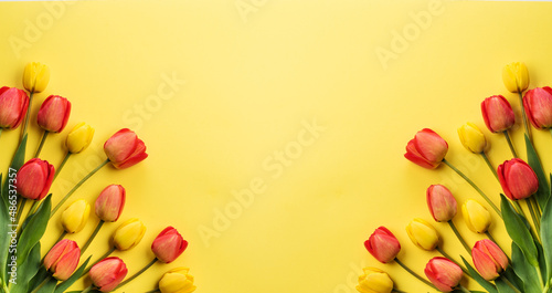 Composition of beautiful flowers of tulips on a yellow background. Flowers background.Top view, copy space.