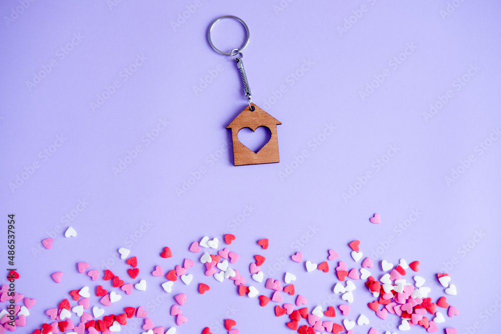 Valentine's day concept many small hearts and keychain on purple background