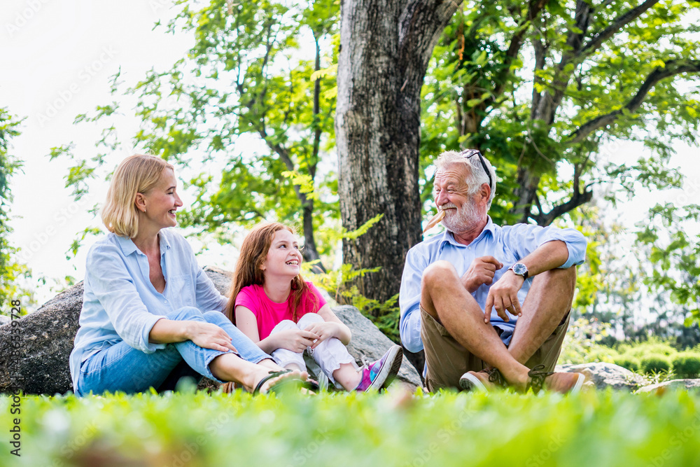 Happy family parent and child relax in weekend holiday lifestyle park outdoor nature background.