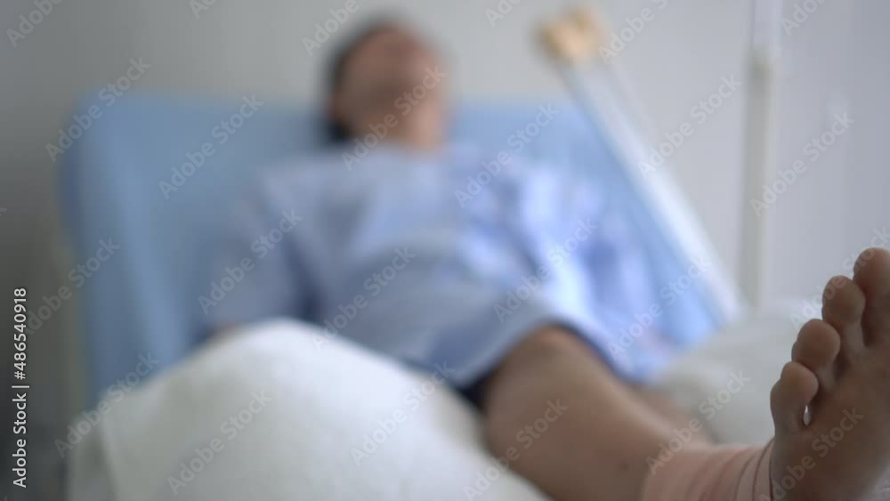 Asian man hurt his leg from accident lying on bed recovery hurt and tired Asian man hurt his leg from accident lying on bed recovery hurt and tired