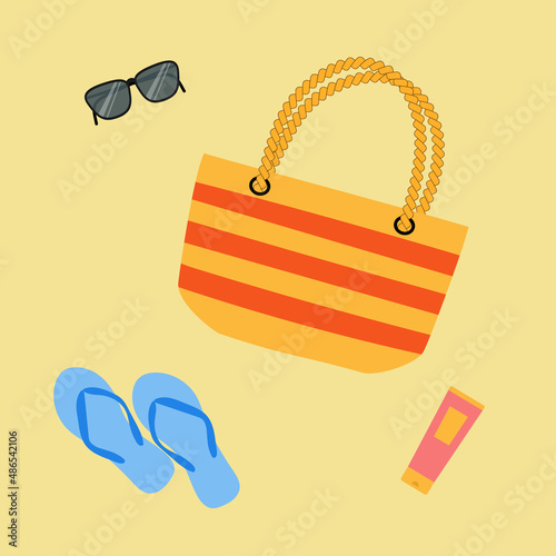 Summer bag, sunglasses, flip flops and suncream on sand. Good for vacation poster, beach party invitation, summer design