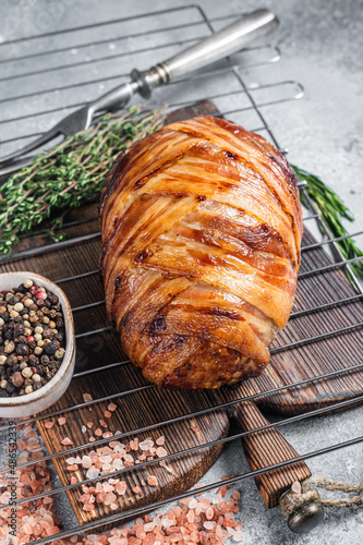 Baked meatloaf with bacon, meat loaf on a grill. Gray background. Top view photo