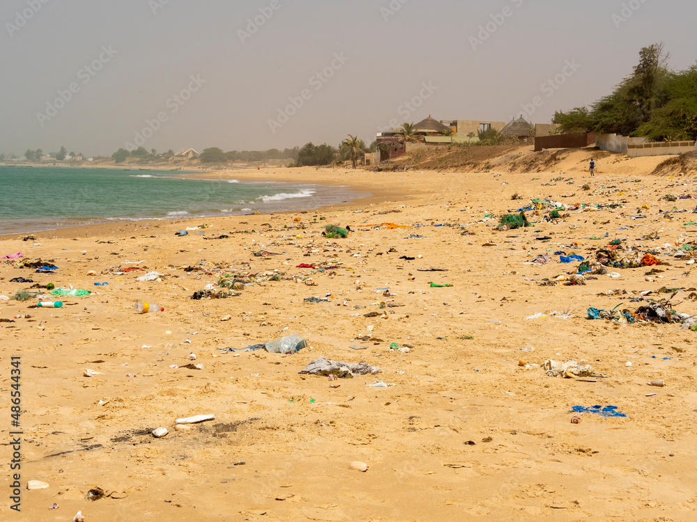 Beach sand and ocean with so many garbage plastic pollution in Senegal Beach sand and ocean with so many garbage plastic pollution in Senegal