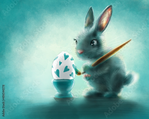 Ilustracja - świąteczny królik malujący jajko w serduszka.