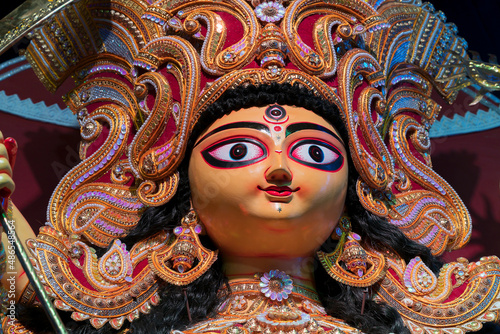 Face of Goddess Durga idol , Durga Puja festival at night. Shot under colored light at Howrah, West Bengal, India. photo