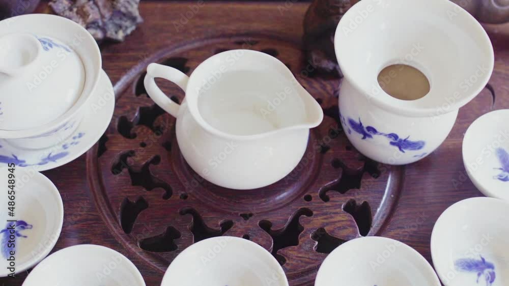 There is a tea set on a beautiful wooden tray There is a tea set on a beautiful wooden tray