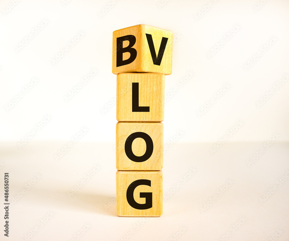 Blog or Vlog symbol. Turned a wooden cube and changed the word Blog to Vlog. Beautiful white table white background. Business and information blog or vlog concept. Copy space. Blog or Vlog symbol. Turned a wooden cube and changed the word Blog to Vlog. Beautiful white table white background. Business and information blog or vlog concept. Copy space.