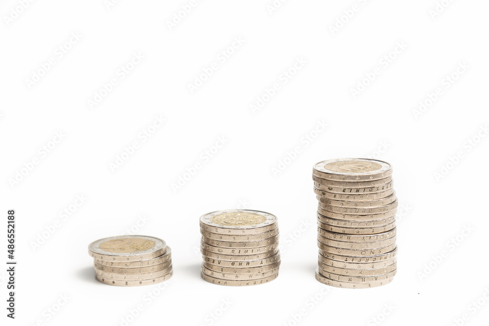 three piles of two euro coins isolated in white three piles of two euro coins isolated in white