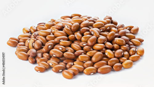 Dried orange beans on a white plate.