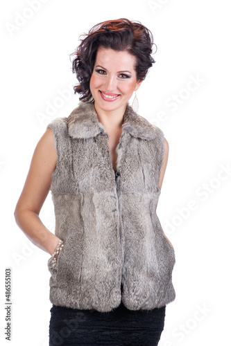 Young beautiful woman in a fur vest.