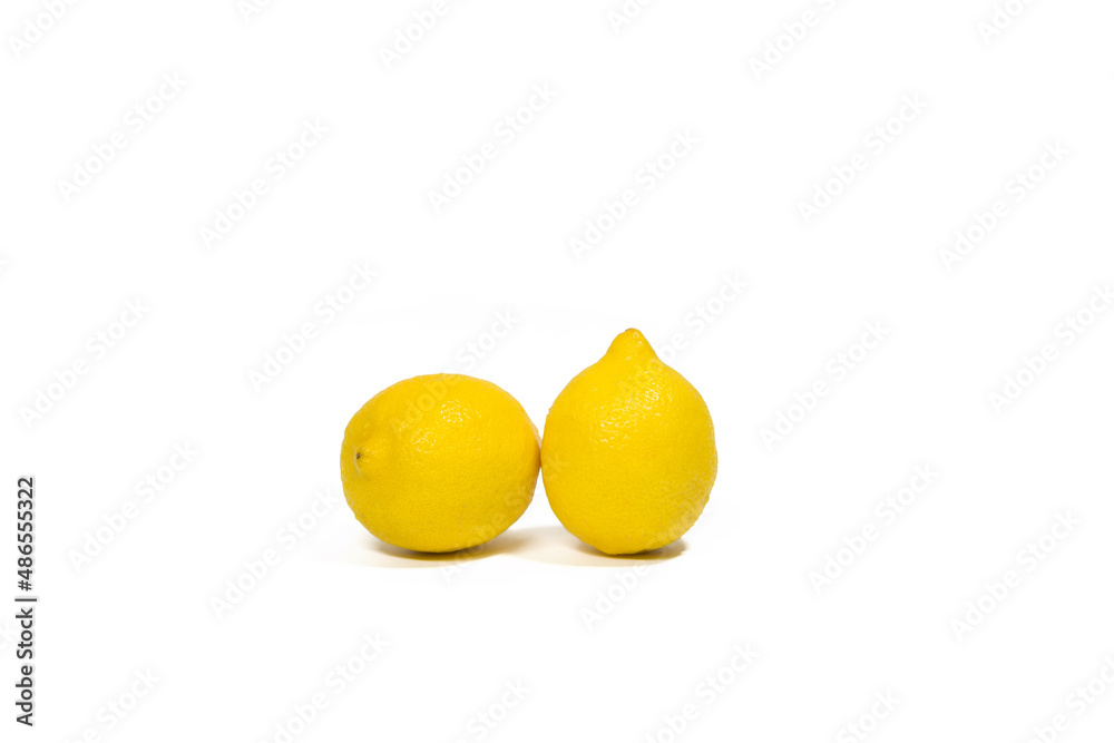 Two yellow lemons lie on a white background isolated Two yellow lemons lie on a white background isolated
