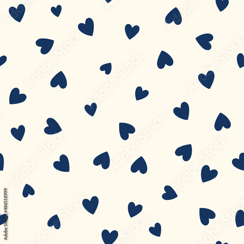 All over seamless vector repeat pattern with ditsy small navy blue hand drawn doodle hearts tossed on cream background. Simple cute Valentines day background