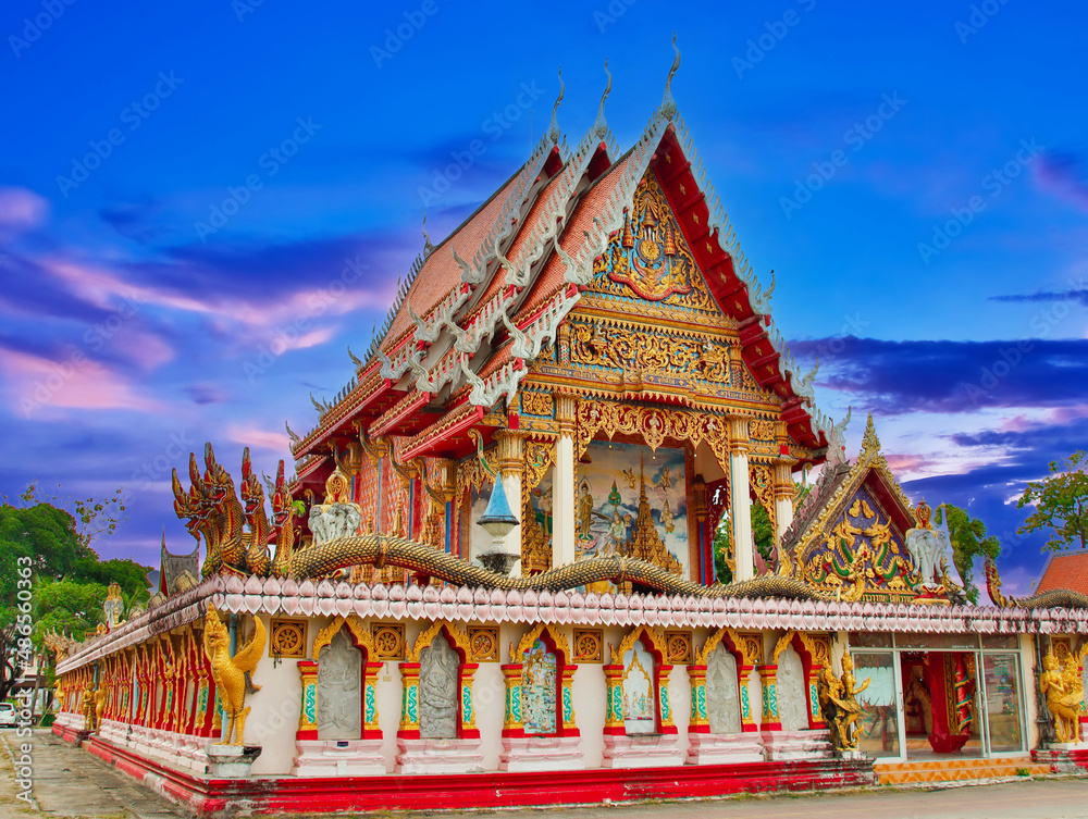 beautiful Way Buddhist temples in Phuket Thailand. Decorated in beautiful ornate colours of red and Gold and Blue. Lovely sunset