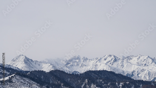 Misty snowy mountain peaks on a cloudy day