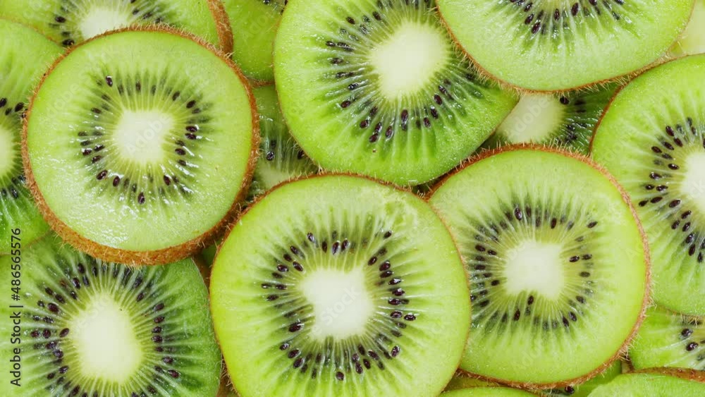 Green kiwi rotating top view, fresh and ripe sweet fruits circles. Healthy eating, vitamins, vegetarian lifestyle. Green kiwi rotating top view, fresh and ripe sweet fruits circles. Healthy eating, vitamins, vegetarian lifestyle.