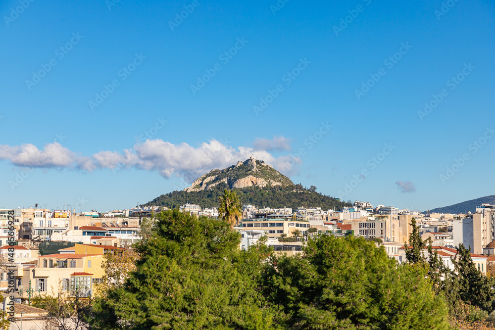 Obraz premium Cityscape of Athens and Lycabettus Hill also known as Lykabettos Lycabettos or Lykavittos. It is a Cretaceous limestone hill in Athens Greece