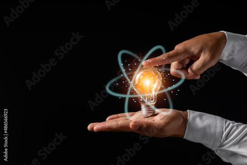 Man holding light bulbs, ideas of new ideas with innovative technology and creativity.