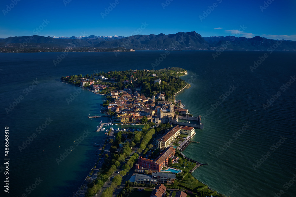 Drone view of Scaliger Castle of Sirmione at sunrise. Sirmione, Lake Garda, Italy aerial view. Sirmione on Lake Garda drone view. Sirmione, Lake Garda, Italy.