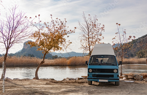 Wallpaper Mural Sweet blue caravan parked by the lake. Autumn season. Naked tree. Beautiful landscape. Torontodigital.ca