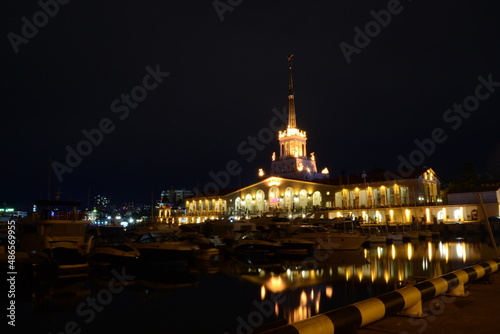 The night port is reflected in the water in bright lights