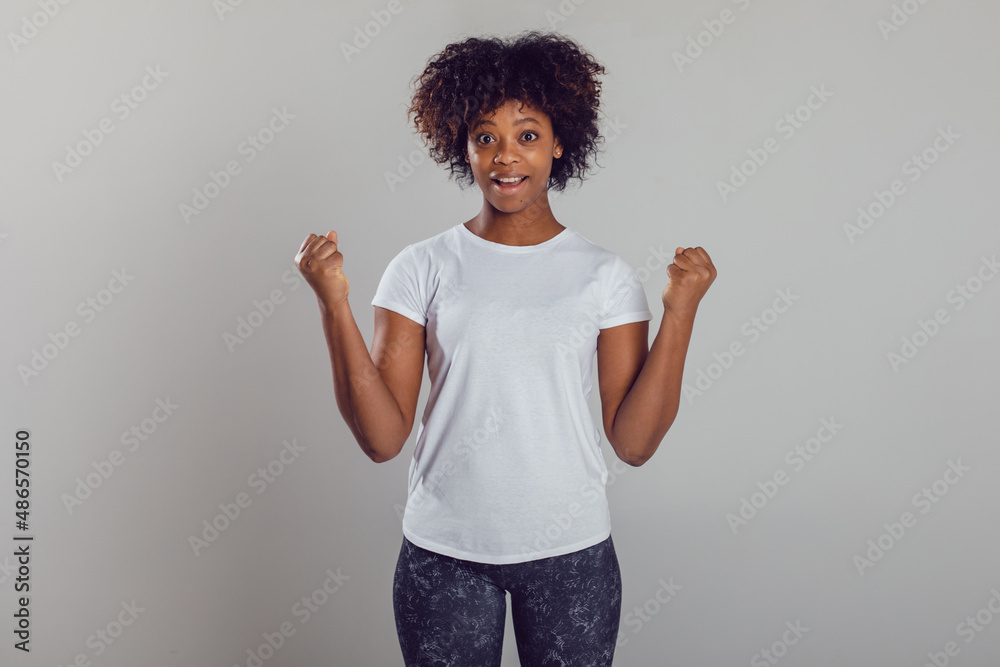 African american woman with puffy hair in a white t-shirt on a white background. Mock-up.