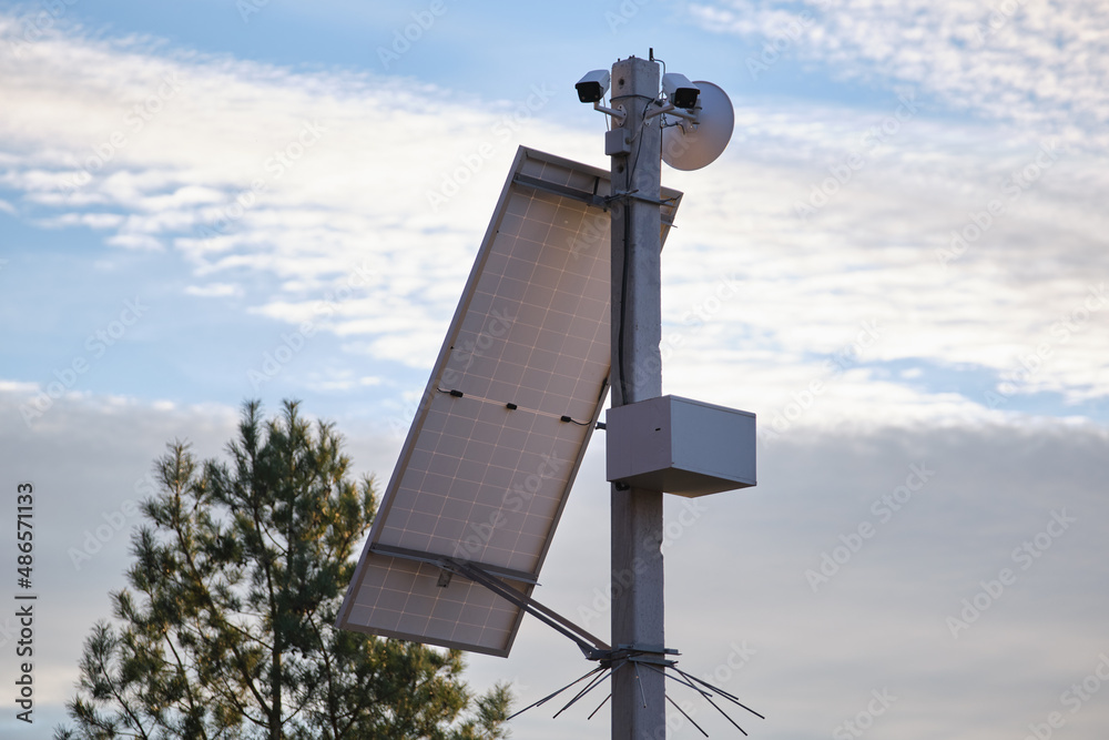 Solar photovoltaic panels mounted on city street pole for electricity supply of streetlights and surveillance cameras Solar photovoltaic panels mounted on city street pole for electricity supply of streetlights and surveillance cameras