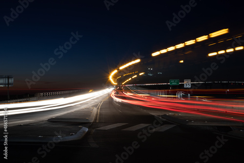 Light trails of cars on a bridge at night