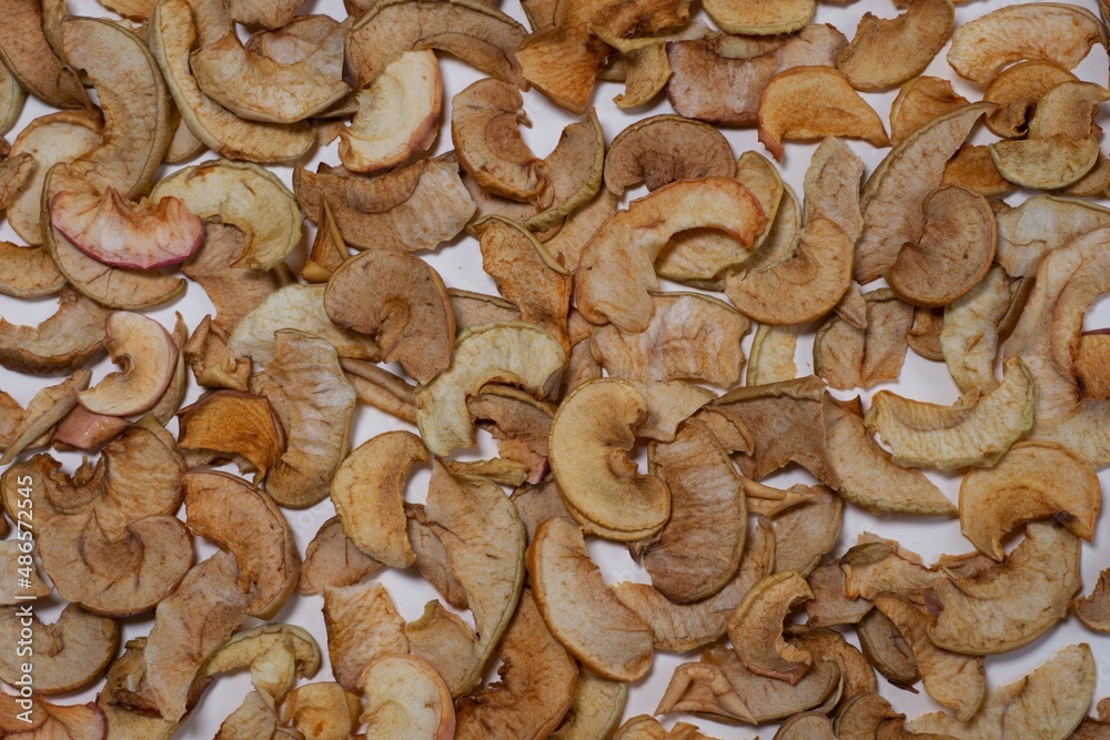 Dried apple slices on a white background. Dried fruits. Dried apple slices on a white background. Dried fruits.