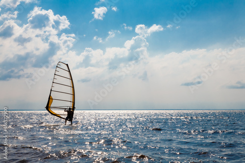 Man on a water sailing windsurfing board. photo