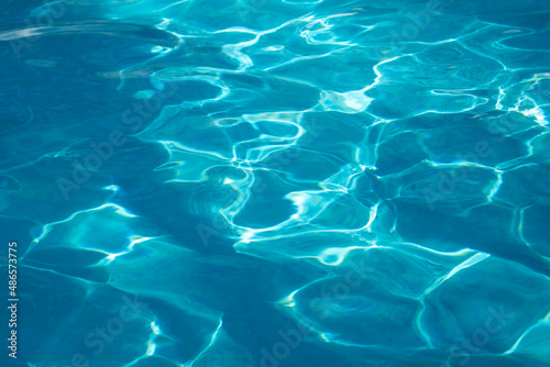 Blue transparent water texture. Waves on the surface of the water background.