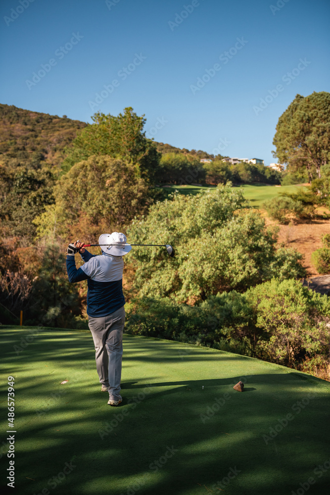 Male golfer playing and swinging on green grass. Male golfer playing and swinging on green grass.