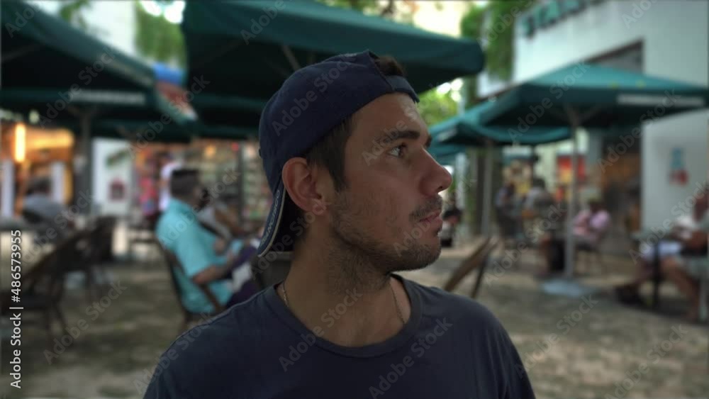 young hispanic man with hat drinks coffee young hispanic man with hat drinks coffee