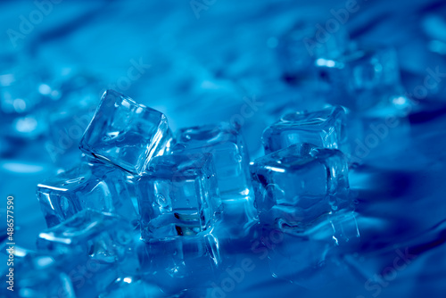 Frosty ice cubes background in blue tone © fox17