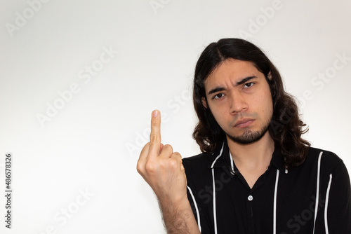 portrait of a very angry, furious and upset hispanic man on a white background