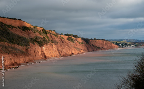 Stunning cliffs and coast path leading to Budleigh Salterton from Exmouth, Devon. Sandstone rock with the sea below. photo