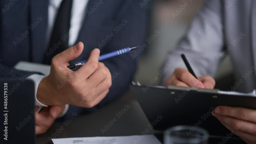 Businessman hands writing document analysing corporate report in company office.