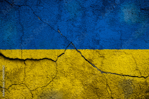 Fototapeta Full frame photo of a weathered flag of Ukraine painted on a cracked wall