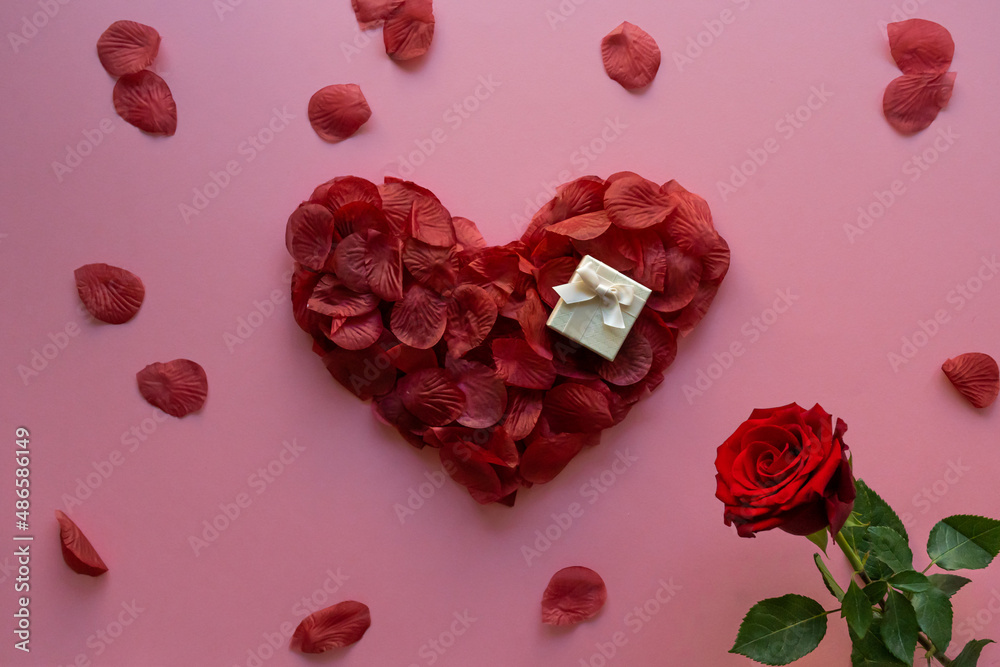 Valentine's day heart made with rose petals and gift box
Valentine's day heart made with rose petals and gift box