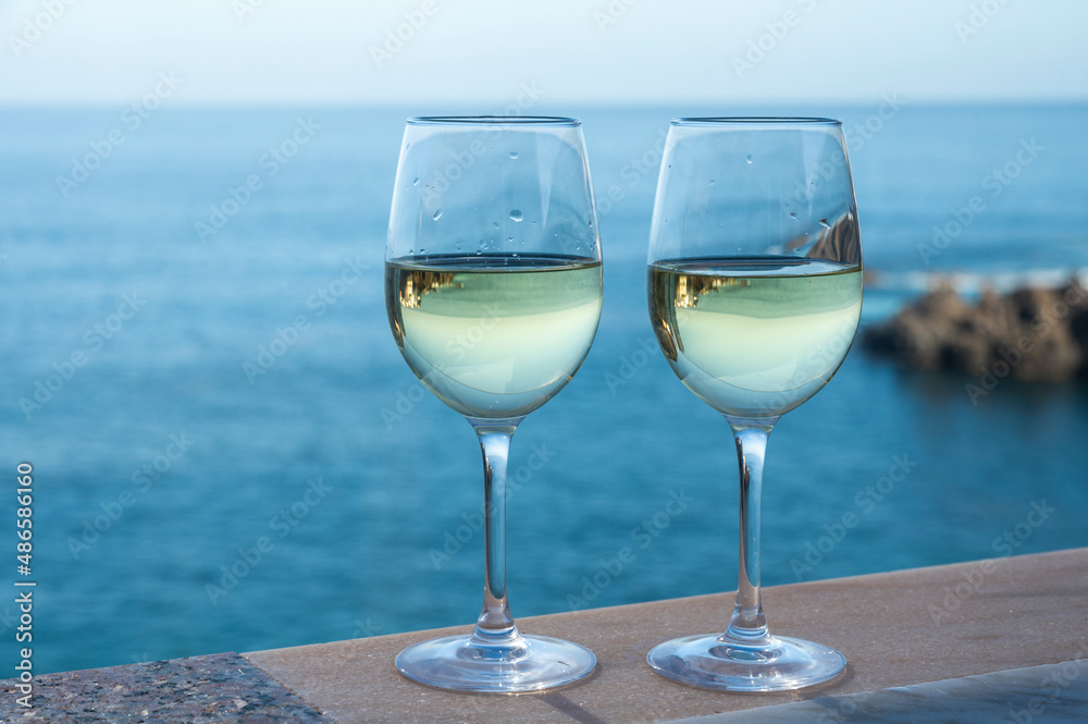 Drinking of white wine with view on blue Atlantic ocean on Tenerife, Canary islands, Spain Drinking of white wine with view on blue Atlantic ocean on Tenerife, Canary islands, Spain